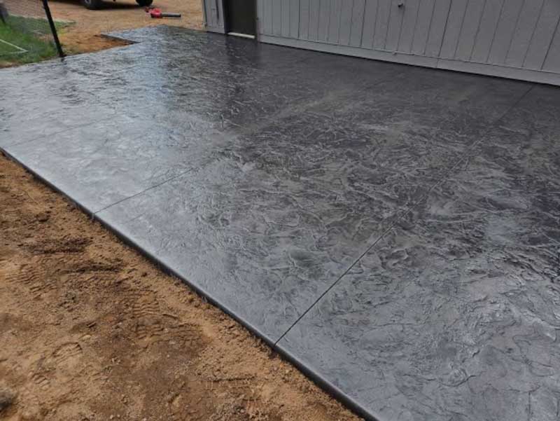 Freshly poured concrete driveway in front of a home