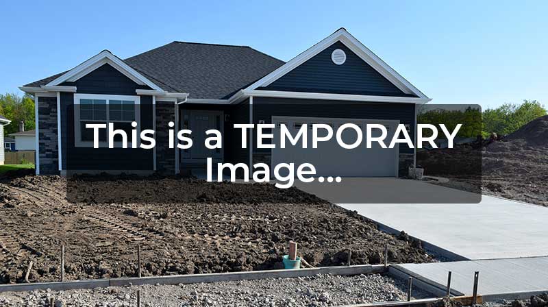 Freshly poured concrete driveway in front of a home