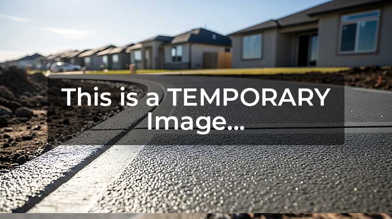Backyard concrete patio surrounding a fire pit
